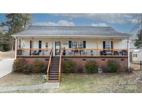 Charming ranch home with a welcoming front porch and brick accents at 1825 Bloomsbury Dr, Rock Hill, SC 29730