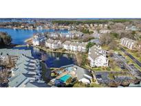 Stunning aerial view of waterfront condos featuring a swimming pool, fountain, and lake access at 18736 Nautical Dr # 201, Cornelius, NC 28031