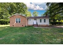 Charming single-story home with brick and siding exterior, set on a lush lawn with mature trees at 3988 Crestview Dr, Rock Hill, SC 29732