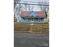 Charming blue house with a red roof and a porch at 414 S Yadkin Ave, Spencer, NC 28159