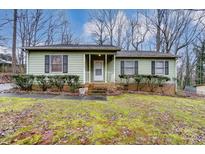 Ranch home with green siding, brick base, and landscaping at 4452 Huntington Dr, Gastonia, NC 28056