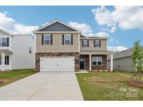 Charming two-story home featuring stone accents, a two-car garage, and a well-manicured lawn at 4618 Harris Elliot Rd, Lincolnton, NC 28092