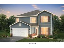 Charming two-story home featuring light blue siding, a two-car garage, and beautifully landscaped front yard at 4796 North Wynswept Dr, Maiden, NC 28650