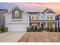 Two-story home with gray siding, brick accents, and a two-car garage at 545 Shallowford Dr, Rock Hill, SC 29732