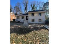 Newly renovated brick house with shutters, front steps, and a grassy yard at 5531 Londonderry Rd, Charlotte, NC 28210