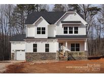 Two-story home with white siding, stone accents, and a two-car garage at 558 Edmunds Ln # 41, Clover, SC 29710