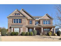 Stunning two-story brick home with symmetrical design, dormer windows, and stone accents at 5600 Ballenger Ct, Waxhaw, NC 28173