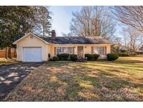 Charming single-story home with a well-maintained front yard and attached one-car garage at 5701 Glenshire Ct, Charlotte, NC 28269