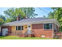 Brick ranch home with attached garage and landscaped lawn at 1007 W Horah St, Salisbury, NC 28144