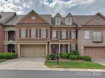 Brick front exterior of charming townhome with two-car garage at 11756 Easthampton Cir, Charlotte, NC 28277