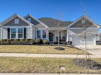 Gray siding one-story house with rocking chairs on the front porch at 12612 Es Draper Dr, Huntersville, NC 28078