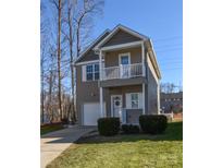 Charming two-story home with a front-facing garage, balcony, manicured lawn and lovely curb appeal at 151 High Bluff Cir, Mooresville, NC 28115