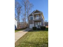 Two-story house with attached garage and landscaped lawn at 151 High Bluff Cir, Mooresville, NC 28115