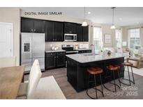 Modern kitchen with island, stainless steel appliances, and granite countertops at 2521 Ellen Ave # 1015D, Charlotte, NC 28208