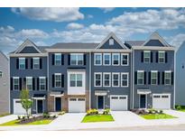 Townhome exteriors feature blue siding, black shutters, white garage doors, and manicured lawns at 3036 Arbor Ash St # 1022B, Charlotte, NC 28208
