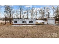 Gray mobile home with carport and detached workshop at 3535 Tines Dr, Midland, NC 28107