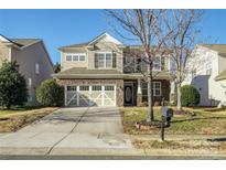 Two-story house with stone accents, two-car garage, and landscaping at 5726 Cactus Valley Rd # 238, Charlotte, NC 28277