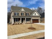 Two-story brick home with a large front porch and a two-car garage at 9811 Ardley Park Way # 30, Mint Hill, NC 28227