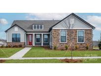 Charming single-Gathering home with stone accents, a red front door, and manicured lawn at 1846 Yardley St, Rock Hill, SC 29732