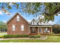 Brick ranch home with front porch and landscaping at 214 Heather Glen Ln, Belmont, NC 28012