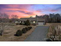 Ranch style home with attached garage and landscaping at 261 Nabors Rd, Statesville, NC 28677