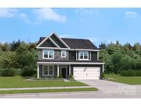 Two-story house with gray siding, stone accents, and a two-car garage at 312 Coronado Ave, Matthews, NC 28104