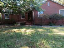 Brick ranch home with a landscaped yard and walkway at 48374 Pfeiffer Pl, Misenheimer, NC 28109