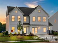 Two-story farmhouse-style home with white siding and landscaping at 5514 Galloway Dr # 63P, Stanfield, NC 28163