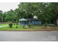 Charming blue house with a well-maintained lawn and mature trees at 700 Oak St, Charlotte, NC 28214