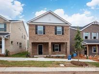 Brick two-story home with a front porch and landscaped lawn at 1225 Colgher St, Mint Hill, NC 28227