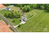 Stunning aerial view of a home on a sprawling green lot with mature trees and a long driveway at 219 Society Rd, Statesville, NC 28625