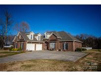 Charming brick home boasts a two-car garage and meticulously maintained landscaping at 219 Society Rd, Statesville, NC 28625