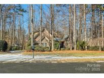 Brick home with stone accents, nestled on a wooded lot at 4915 Magglucci Pl, Mint Hill, NC 28227