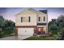Two-story home with brick and siding exterior, two-car garage, and landscaping at 5219 Reedy Ridge Rd, Charlotte, NC 28215