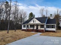 Charming new construction home boasts a inviting front porch and a beautifully landscaped front yard at 522 Birdie Haven Dr # 27, Chester, SC 29706