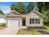 Charming single-story home with a well-manicured front yard and attached garage at 5615 Howard St, Charlotte, NC 28269