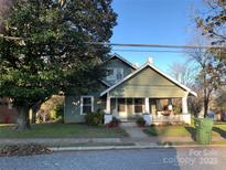 Charming two-story house with a porch and mature trees at 913 9Th Ne Ave, Hickory, NC 28601