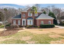 Charming two-story brick home with landscaped front yard and mature tree at 133 Castaway Trl, Mooresville, NC 28117