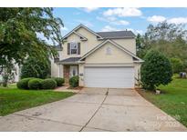 Two-story house with attached garage and landscaping at 2111 Bennett Woods Ct, Charlotte, NC 28216