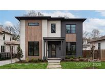 Modern two-story home with gray and white siding, wood accents, and a landscaped lawn at 308 Dover Ave, Charlotte, NC 28209