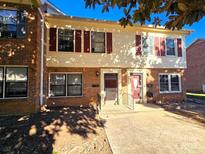 Brick front townhouse with red shutters and a small front yard at 4663 Old Lantern Way, Charlotte, NC 28212