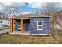 Newly renovated home featuring a charming front porch and updated exterior at 503 Birch St, Lowell, NC 28098