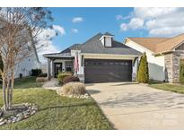 Craftsman style home with a 2 car garage and landscaped front yard at 6297 Raven Rock Dr, Denver, NC 28037