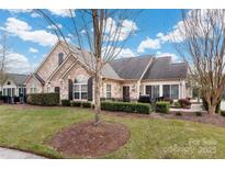 Inviting exterior of charming ranch home with stone accents and landscaped yard at 874 Ledgestone Ct, Tega Cay, SC 29708