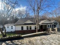 Updated craftsman style home with brick accents and paved driveway at 1325 Bostwood Ln, Concord, NC 28025