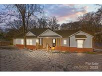 Charming craftsman style home with brick accents and a landscaped yard at 1325 Bostwood Ln, Concord, NC 28025