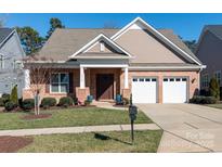 Brick ranch home with two-car garage and landscaped lawn at 14310 Cameryn Elise Dr, Cornelius, NC 28031