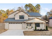 Two-story brick home with a large front yard and attached two-car garage at 1938 Grace Ln, Charlotte, NC 28262