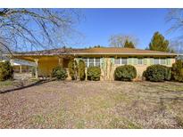 Brick ranch house with covered porch, mature landscaping, and large yard at 194 Bynum Rd, Lincolnton, NC 28092