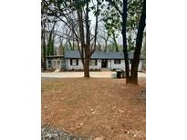 Charming single-story home with a neatly maintained front yard and mature trees offering shade at 217 Ruby Ln, Gastonia, NC 28054